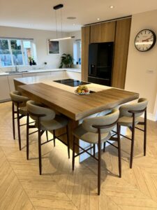 Luxury bespoke kitchen with statement island, fluted oak detailing and seating for four